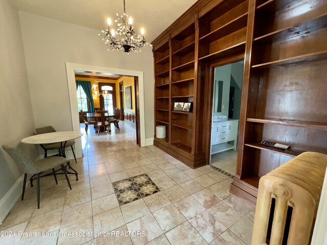 interior space with radiator heating unit and a chandelier