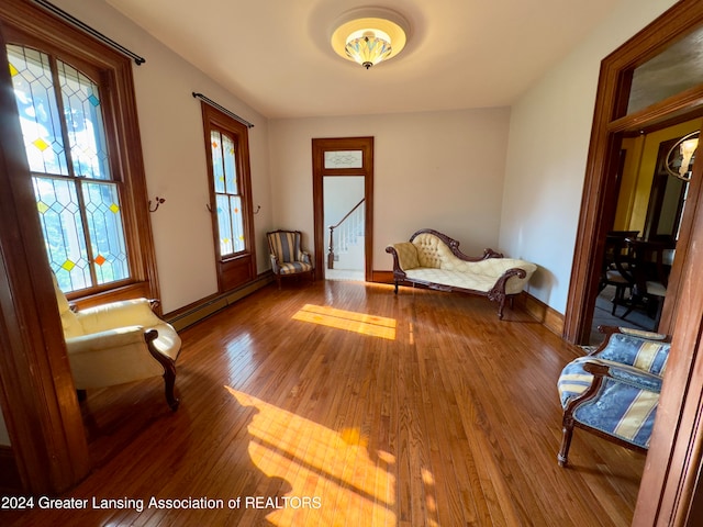 foyer entrance featuring a baseboard heating unit and hardwood / wood-style floors