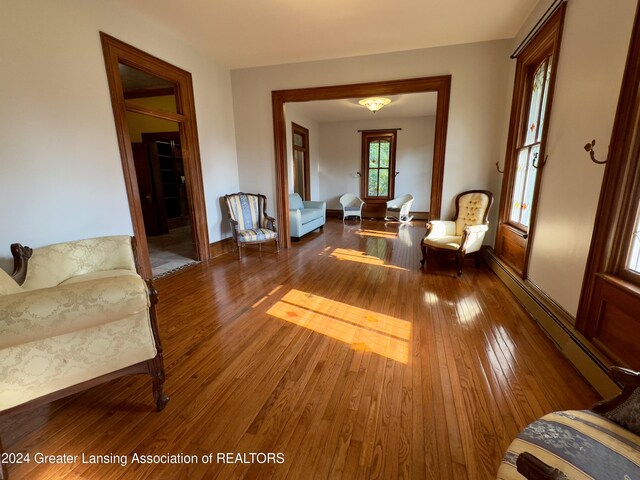 interior space featuring a baseboard heating unit and wood-type flooring