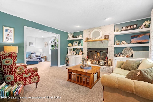 living room featuring a textured ceiling, a stone fireplace, carpet flooring, and built in features