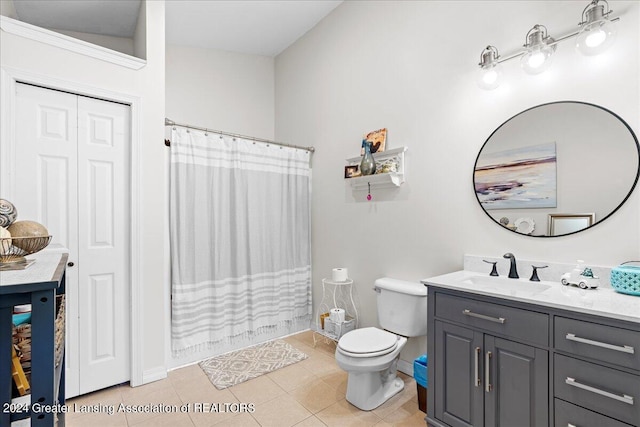 bathroom featuring curtained shower, vanity, toilet, and tile patterned floors