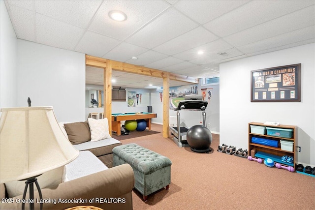 living room with carpet floors and a drop ceiling