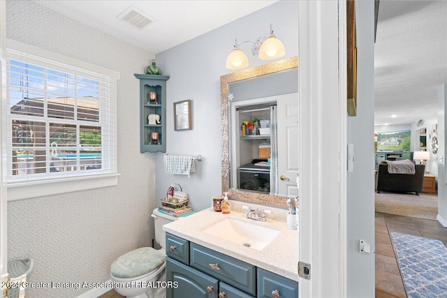 bathroom featuring tile patterned flooring, vanity, and toilet