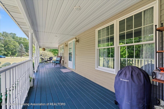 wooden deck featuring a grill and covered porch