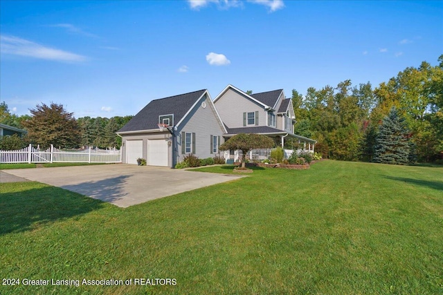 view of side of property with a lawn, a porch, and a garage