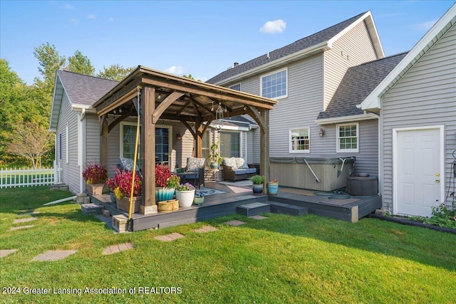 rear view of property with a lawn and a wooden deck