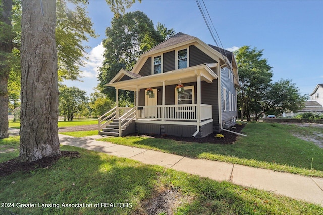 bungalow-style home with a porch and a front lawn