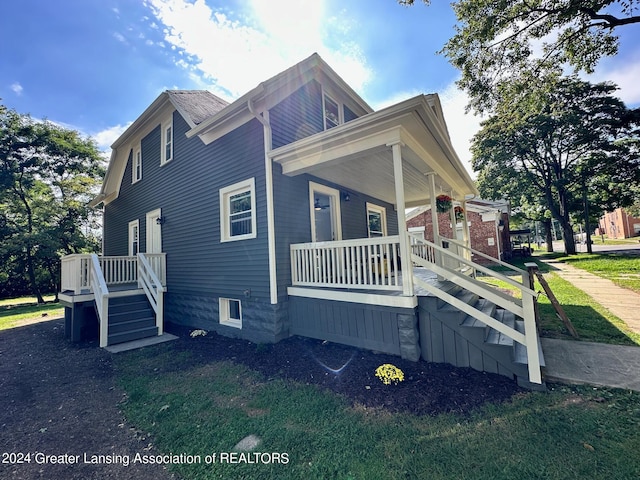 view of side of property with covered porch