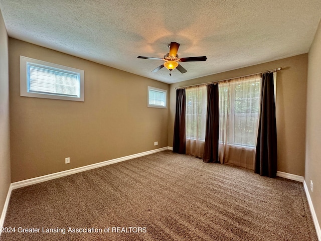 carpeted empty room featuring a textured ceiling and ceiling fan