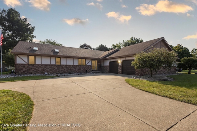 view of front of house featuring a garage and a front lawn