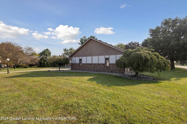 view of property exterior featuring a lawn