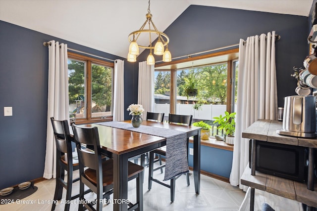 dining area with lofted ceiling and a chandelier