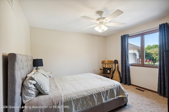 carpeted bedroom with ceiling fan