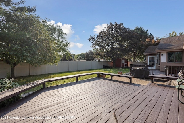 deck featuring a yard and a shed