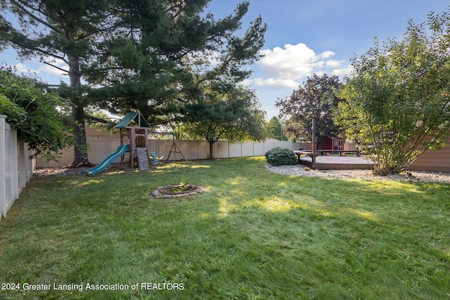 view of yard featuring a playground and a wooden deck