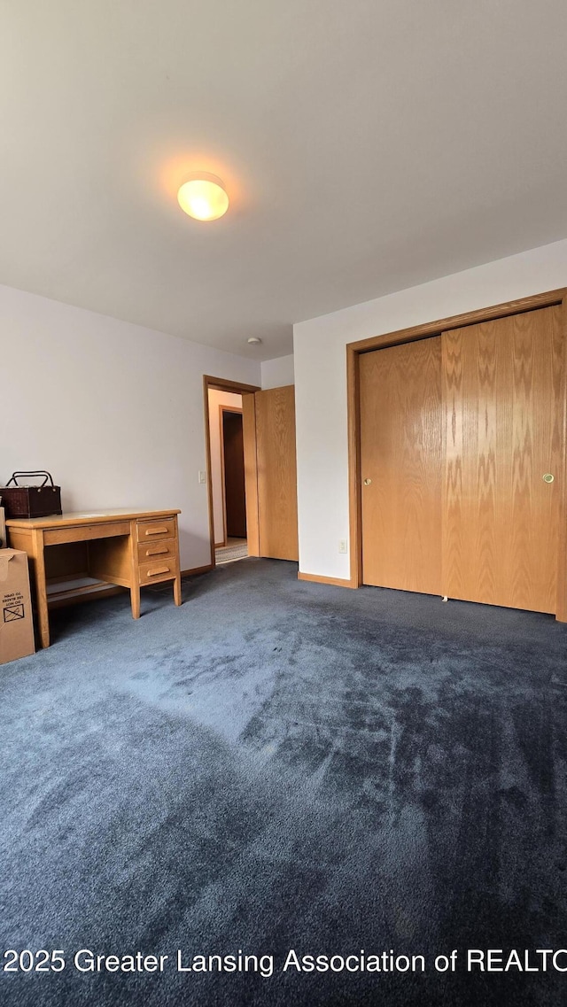 1205 N Chester Rd, Charlotte, MI 48813 - unfurnished bedroom featuring carpet flooring and baseboards