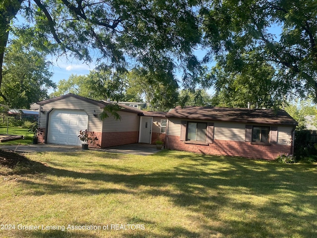 ranch-style house with a garage and a front lawn