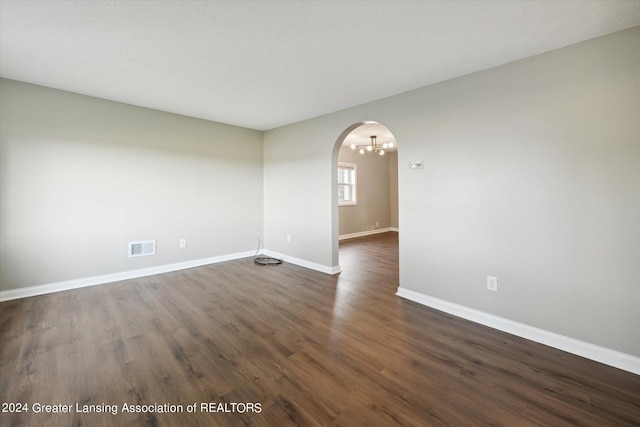 spare room with dark wood-type flooring