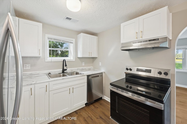 kitchen featuring white cabinetry, appliances with stainless steel finishes, sink, and dark hardwood / wood-style floors