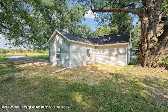 view of property exterior with a yard