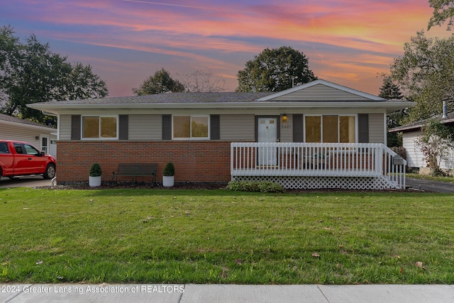 ranch-style house featuring a lawn