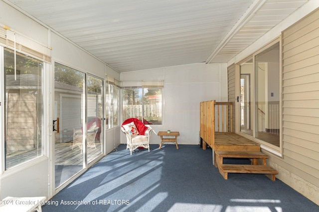 sunroom / solarium featuring lofted ceiling