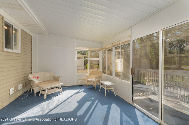 unfurnished sunroom featuring wood ceiling and lofted ceiling