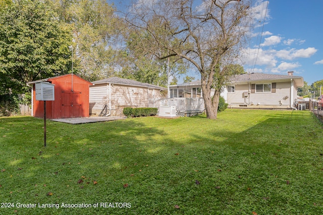 view of yard with a shed and a deck