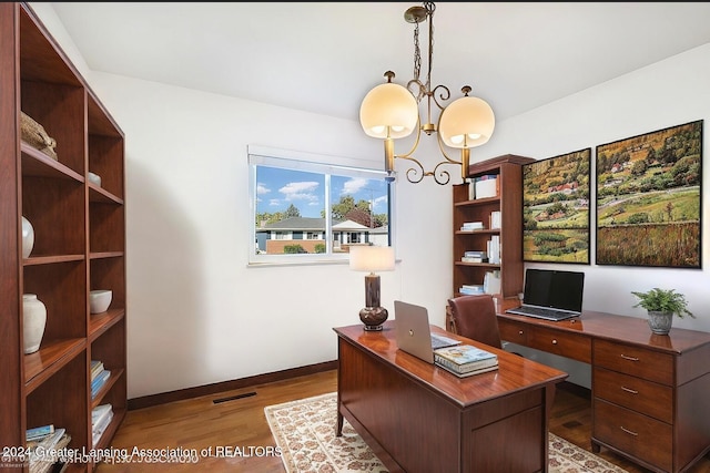 home office featuring a chandelier and wood-type flooring