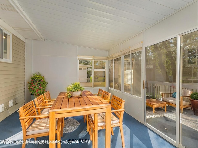 sunroom featuring wooden ceiling and lofted ceiling