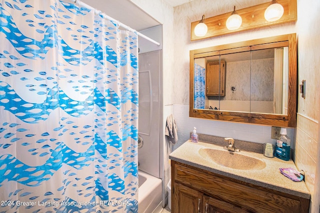 bathroom featuring shower / bathtub combination with curtain, backsplash, tile walls, and vanity