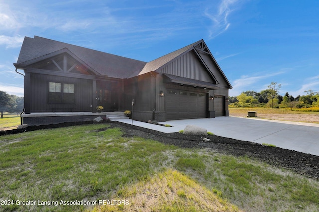 view of front of home with a garage and a front lawn