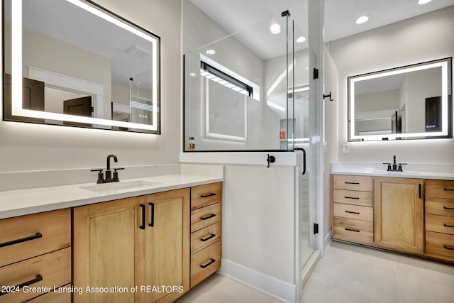 bathroom featuring vanity, an enclosed shower, and tile patterned flooring