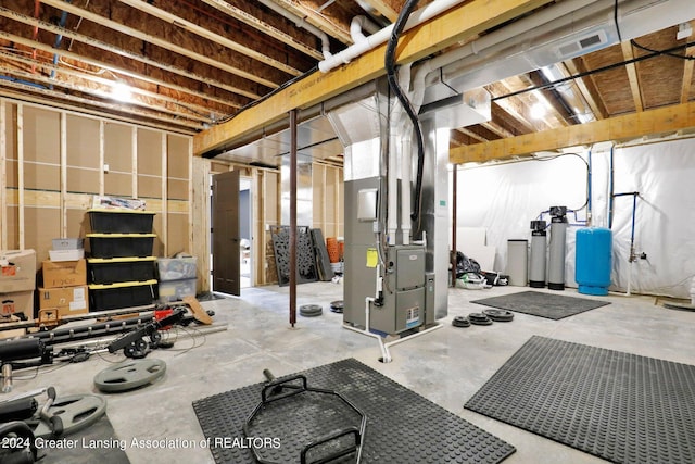 workout area with heating unit and concrete flooring