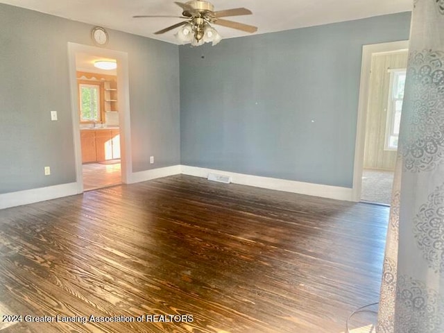 spare room featuring ceiling fan and dark hardwood / wood-style flooring