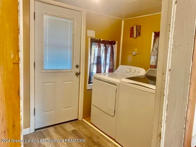 washroom with light hardwood / wood-style floors and separate washer and dryer