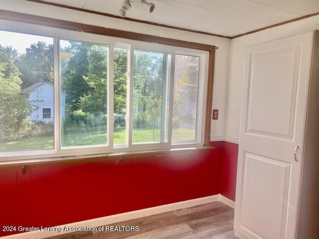 interior space featuring baseboards and wood finished floors