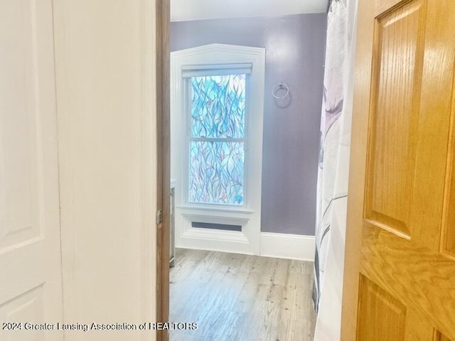 bathroom featuring baseboards and wood finished floors