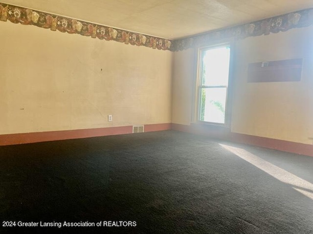 carpeted spare room with visible vents