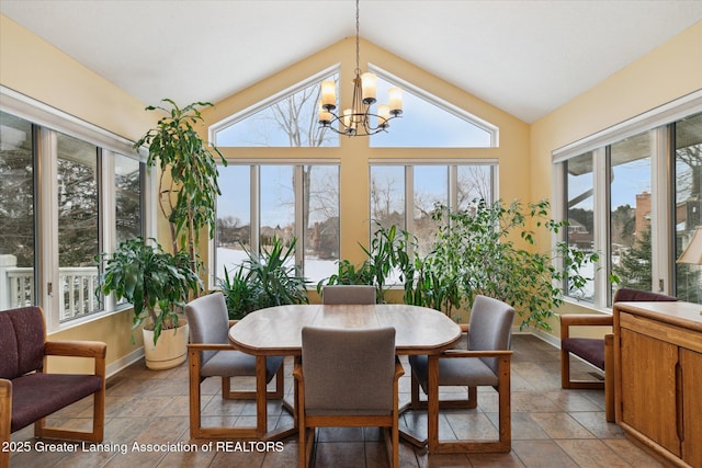 sunroom / solarium with vaulted ceiling and an inviting chandelier