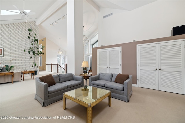 carpeted living room featuring beamed ceiling, ceiling fan, rail lighting, and high vaulted ceiling