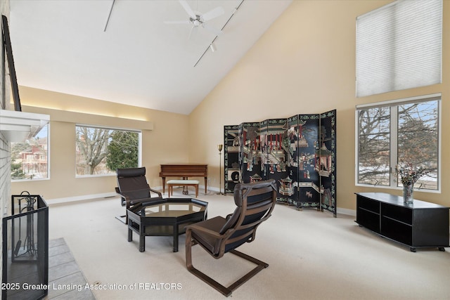 dining space featuring rail lighting, carpet flooring, ceiling fan, and high vaulted ceiling