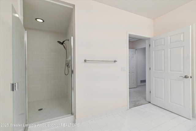 bathroom featuring tile patterned floors and a shower with door