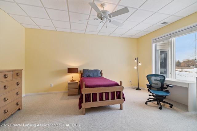 carpeted bedroom with a paneled ceiling