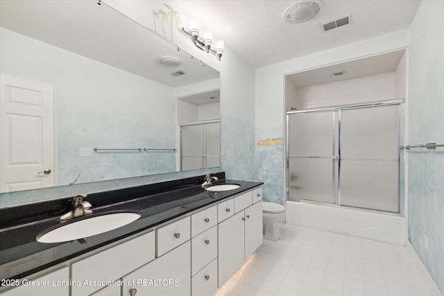 full bathroom featuring vanity, toilet, and combined bath / shower with glass door