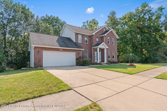 view of front of house with a garage and a front yard