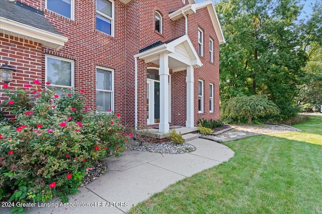 doorway to property with a yard