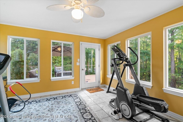 workout room with a wealth of natural light, ceiling fan, and light tile patterned flooring