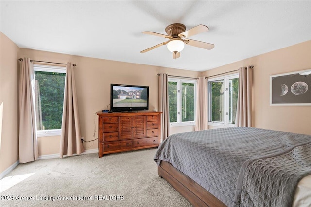 bedroom with ceiling fan and light carpet