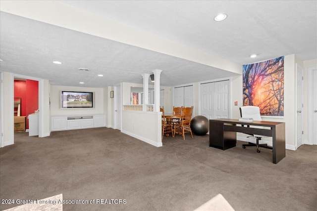 carpeted home office featuring a textured ceiling